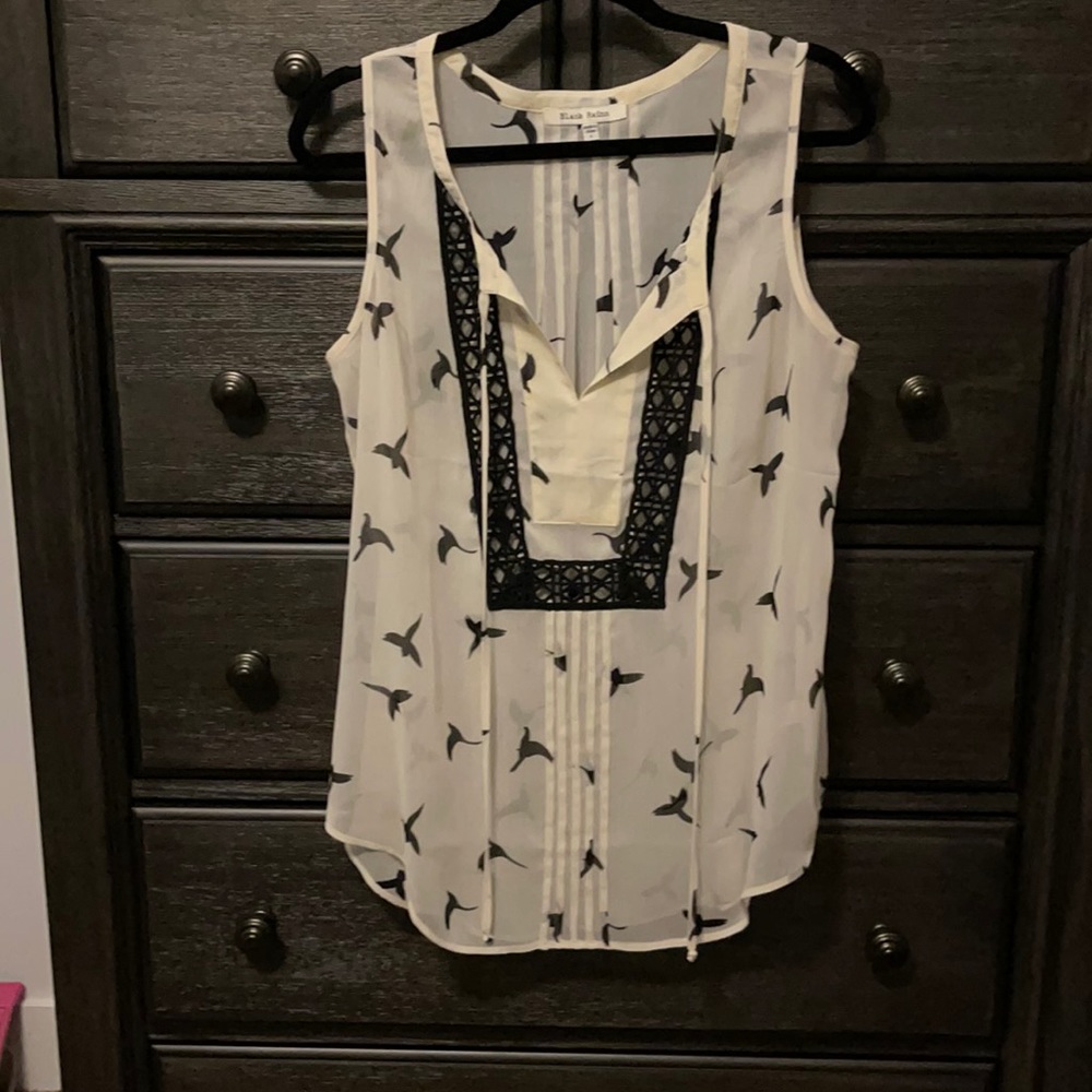 Sleeveless see through blouse with black birds on it.
